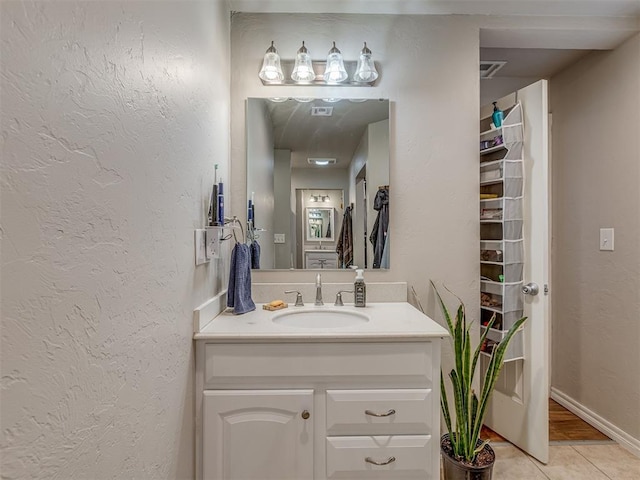 1072 County St Unit 2958, Tuttle, OK 73089 - bathroom featuring vanity, a textured wall, and tile patterned flooring