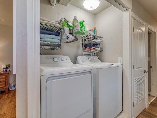 1072 County St Unit 2958, Tuttle, OK 73089 - laundry room with independent washer and dryer, wood finished floors, and a textured wall
