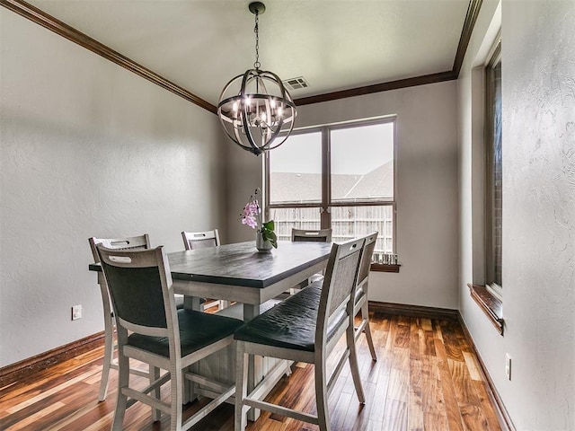 1808 Lago Dr, Moore, OK 73160 - dining room featuring a chandelier, ornamental molding, hardwood / wood-style flooring, a textured wall, and baseboards
