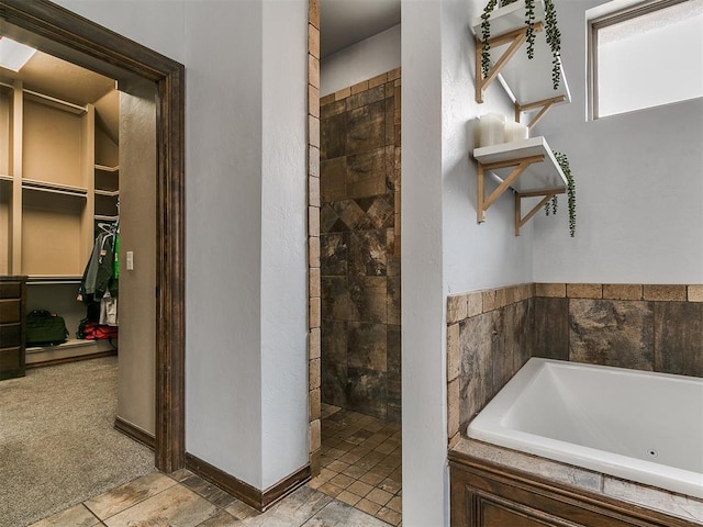 1808 Lago Dr, Moore, OK 73160 - bathroom featuring a jetted tub, tiled shower, and a spacious closet