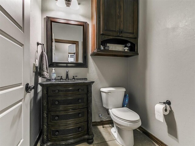 1808 Lago Dr, Moore, OK 73160 - half bath with toilet, vanity, baseboards, and tile patterned floors