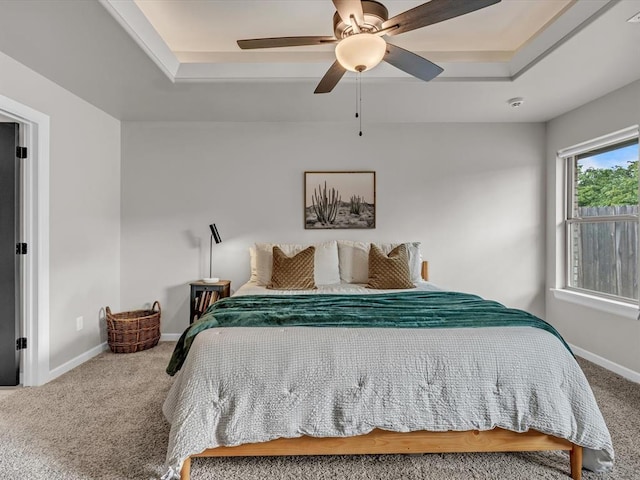 8332 Poplar Dr, Edmond, OK 73034 - bedroom with carpet flooring, a raised ceiling, and ceiling fan