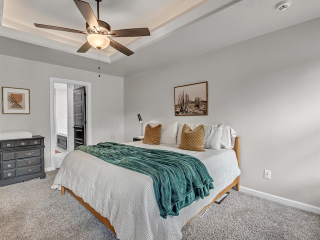 8332 Poplar Dr, Edmond, OK 73034 - carpeted bedroom with a raised ceiling, ceiling fan, and ensuite bath