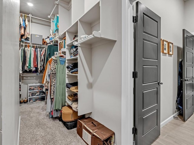 8332 Poplar Dr, Edmond, OK 73034 - walk in closet featuring light colored carpet