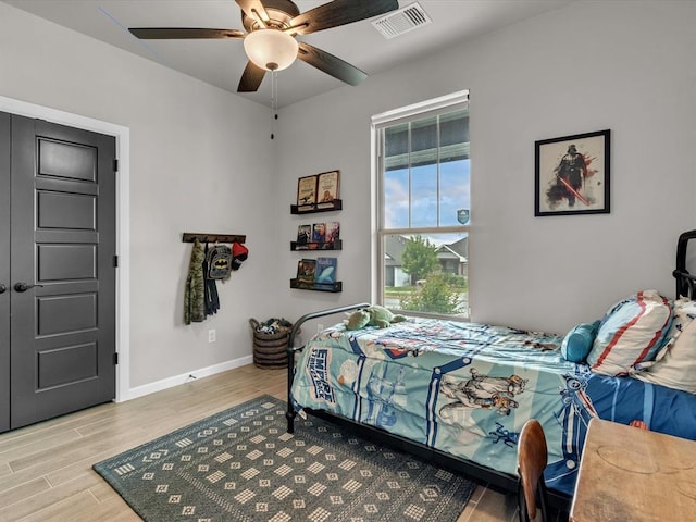 8332 Poplar Dr, Edmond, OK 73034 - bedroom with light wood finished floors and ceiling fan