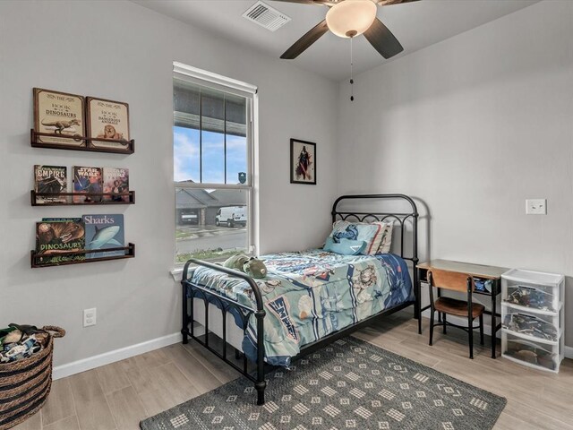 8332 Poplar Dr, Edmond, OK 73034 - bedroom with wood finished floors and ceiling fan