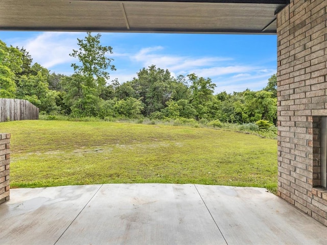 8332 Poplar Dr, Edmond, OK 73034 - view of grassy yard featuring a patio and a wooded view