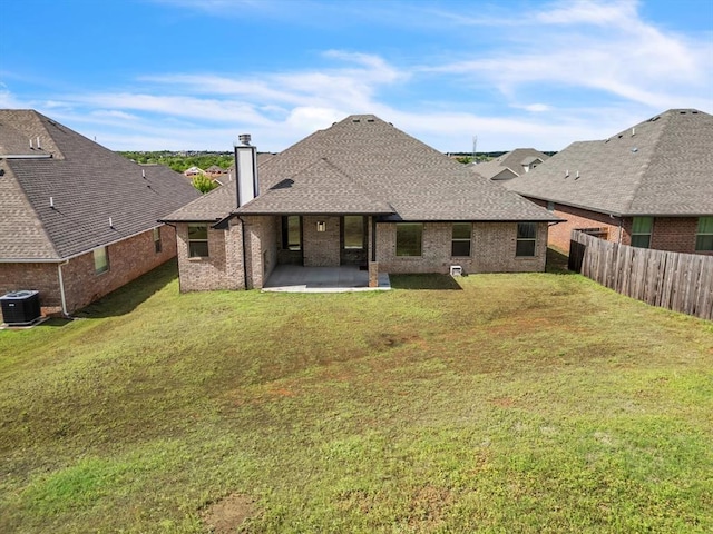 8332 Poplar Dr, Edmond, OK 73034 - back of house featuring a chimney, a patio, a shingled roof, and brick siding