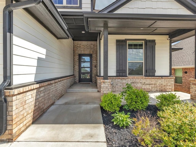 8332 Poplar Dr, Edmond, OK 73034 - entrance to property featuring brick siding and a porch