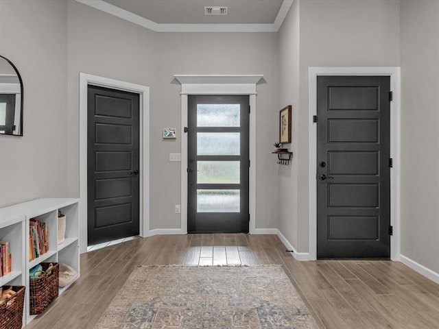 8332 Poplar Dr, Edmond, OK 73034 - foyer with wood finished floors and crown molding