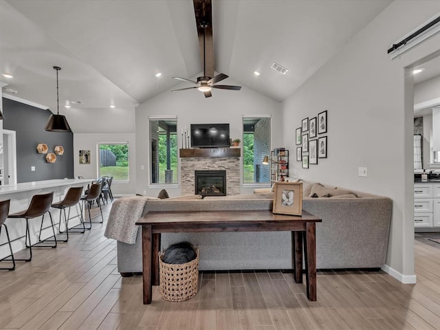 8332 Poplar Dr, Edmond, OK 73034 - living room featuring light wood-style floors, a stone fireplace, ceiling fan, and recessed lighting