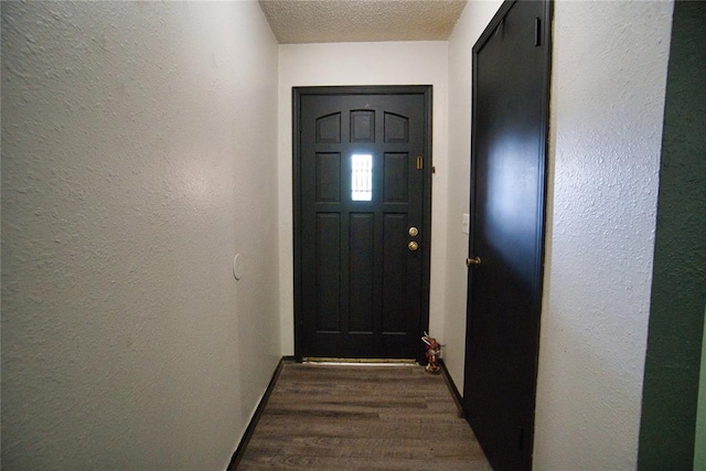 1208 Cathy Ln, Oklahoma City, OK 73110 - doorway to outside with a textured wall, a textured ceiling, and dark wood-type flooring