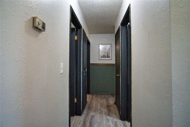 1208 Cathy Ln, Oklahoma City, OK 73110 - hall with a textured wall, wood finished floors, and a textured ceiling