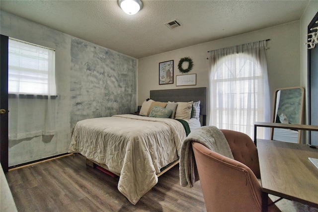 1208 Cathy Ln, Oklahoma City, OK 73110 - bedroom featuring wood finished floors and a textured ceiling