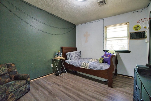 1208 Cathy Ln, Oklahoma City, OK 73110 - bedroom with wood finished floors, a textured ceiling, and baseboards