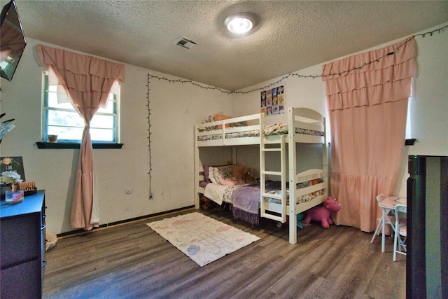 1208 Cathy Ln, Oklahoma City, OK 73110 - bedroom featuring wood finished floors and a textured ceiling