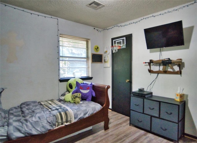 1208 Cathy Ln, Oklahoma City, OK 73110 - bedroom with a textured ceiling and light wood-type flooring