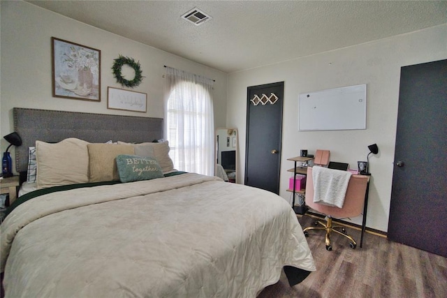 1208 Cathy Ln, Oklahoma City, OK 73110 - bedroom featuring wood finished floors and a textured ceiling