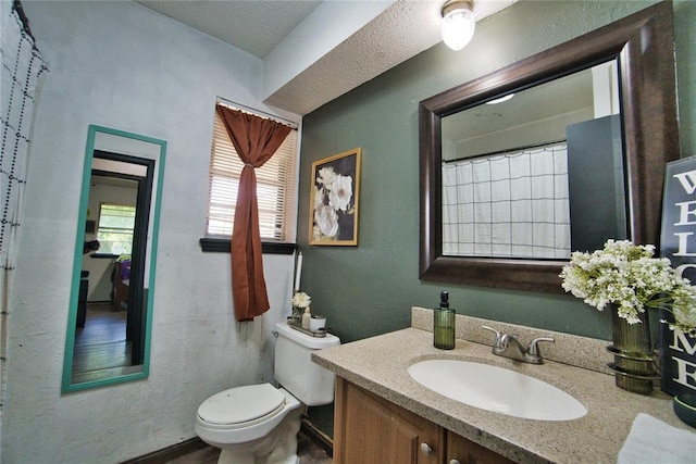 1208 Cathy Ln, Oklahoma City, OK 73110 - full bath featuring toilet, vanity, a textured wall, and a textured ceiling