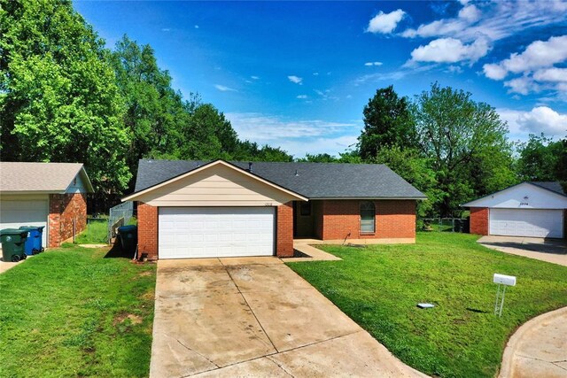 1208 Cathy Ln, Oklahoma City, OK 73110 - ranch-style house featuring a front yard, brick siding, driveway, and an attached garage