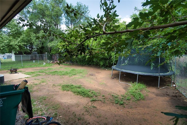 1208 Cathy Ln, Oklahoma City, OK 73110 - view of yard with a trampoline and fence