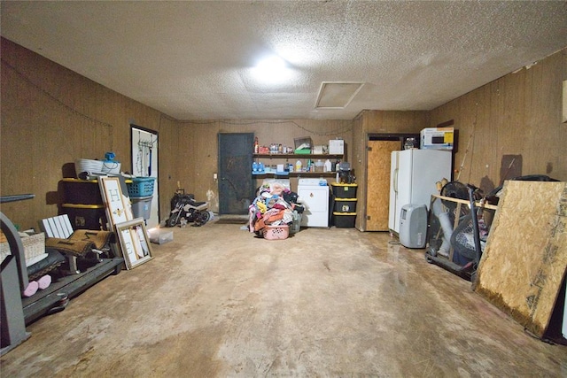 1208 Cathy Ln, Oklahoma City, OK 73110 - garage with wooden walls, refrigerator, and freestanding refrigerator