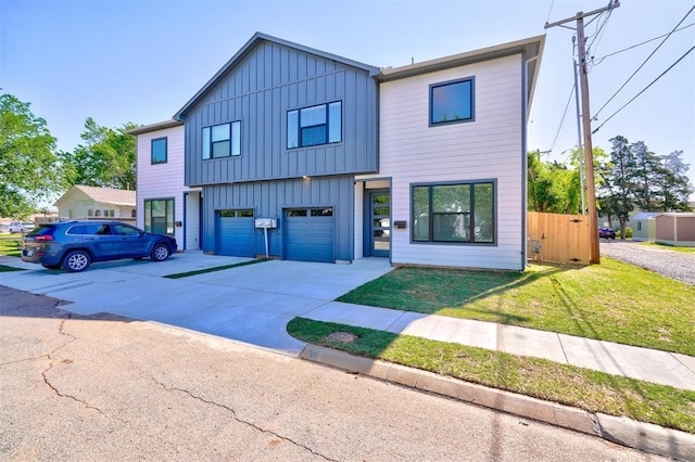 view of front of house featuring board and batten siding, concrete driveway, a garage, and a front lawn