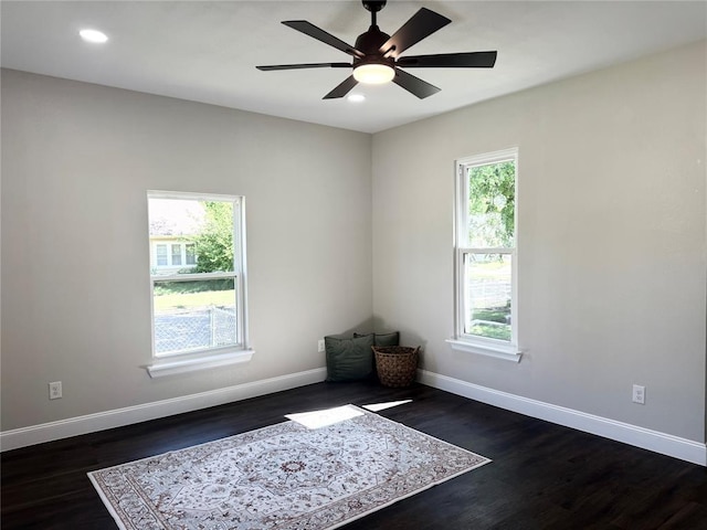 empty room with dark wood-style flooring, baseboards, a ceiling fan, and recessed lighting