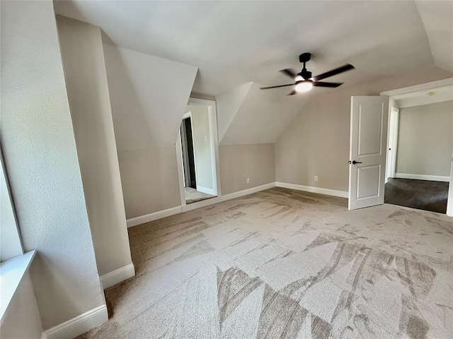 additional living space featuring ceiling fan, vaulted ceiling, baseboards, and carpet