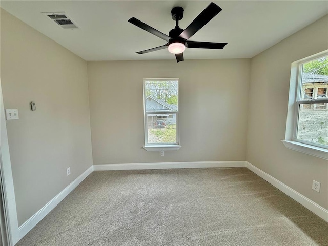 empty room with baseboards, carpet, and a ceiling fan
