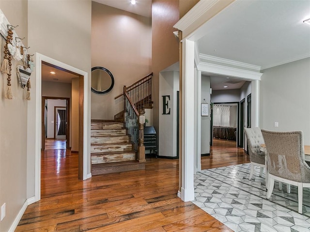 3133 Beacon Hill St, Edmond, OK 73034 - foyer entrance featuring wood finished floors, stairway, and crown molding