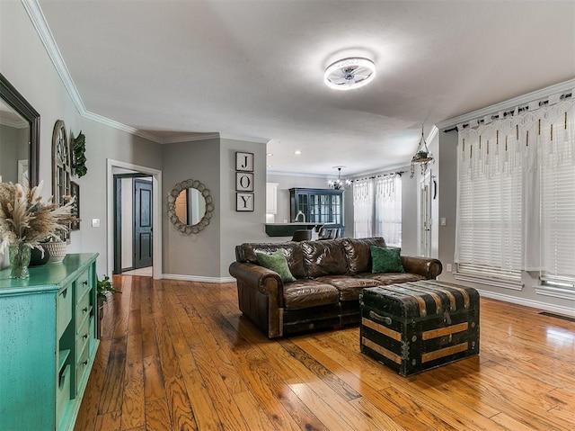 3133 Beacon Hill St, Edmond, OK 73034 - living room featuring hardwood / wood-style flooring, a chandelier, and crown molding