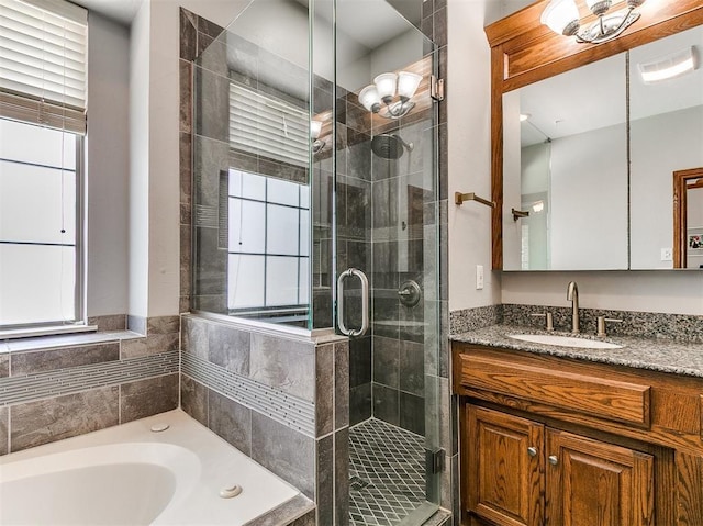 3133 Beacon Hill St, Edmond, OK 73034 - bathroom with vanity, a garden tub, and a stall shower
