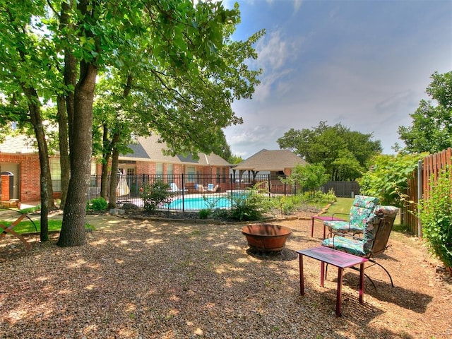 3133 Beacon Hill St, Edmond, OK 73034 - fenced backyard featuring a fire pit and a community pool