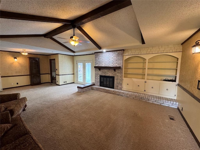 804 William Blvd, Seminole, OK 74868 - unfurnished living room with a ceiling fan, a textured ceiling, carpet flooring, a brick fireplace, and lofted ceiling with beams