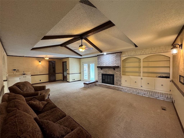 804 William Blvd, Seminole, OK 74868 - living area featuring a textured ceiling, a brick fireplace, carpet floors, and a ceiling fan