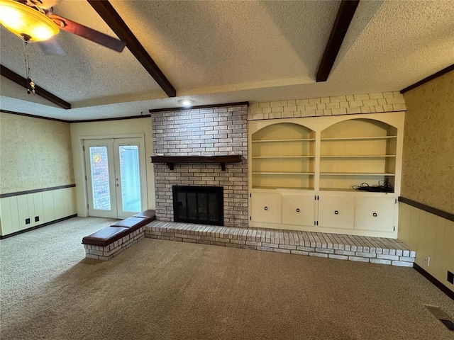 804 William Blvd, Seminole, OK 74868 - unfurnished living room with a wainscoted wall, a textured ceiling, visible vents, and carpet floors
