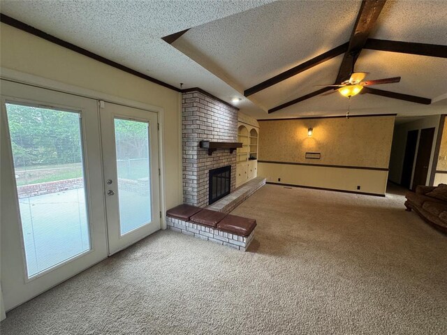 804 William Blvd, Seminole, OK 74868 - unfurnished living room featuring carpet, a ceiling fan, lofted ceiling with beams, a brick fireplace, and a textured ceiling