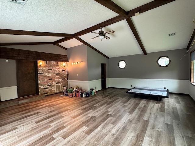 804 William Blvd, Seminole, OK 74868 - unfurnished living room featuring wainscoting, a ceiling fan, visible vents, and wood finished floors
