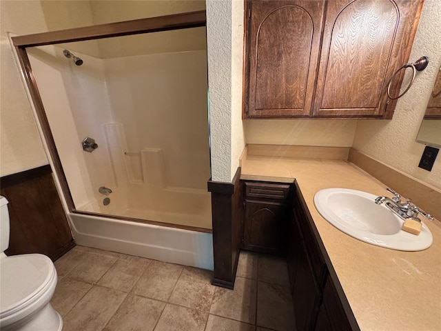 804 William Blvd, Seminole, OK 74868 - full bathroom featuring toilet, vanity, tile patterned flooring, a textured wall, and  shower combination