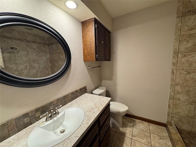 804 William Blvd, Seminole, OK 74868 - bathroom featuring toilet, baseboards, tile patterned floors, vanity, and a textured wall