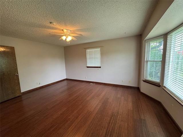 804 William Blvd, Seminole, OK 74868 - spare room featuring a ceiling fan, baseboards, a textured ceiling, and wood finished floors