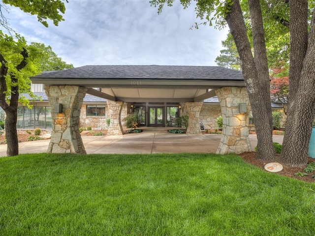 1011 Saint Andrews Dr, Edmond, OK 73025 - rear view of property with stone siding, a yard, french doors, and a shingled roof
