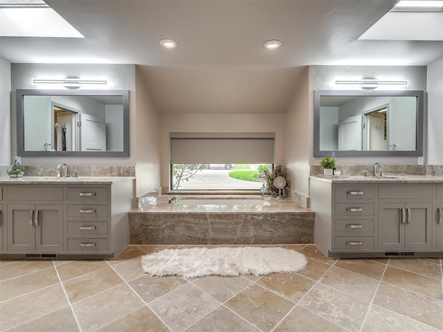 1011 Saint Andrews Dr, Edmond, OK 73025 - bathroom featuring two vanities and a bath