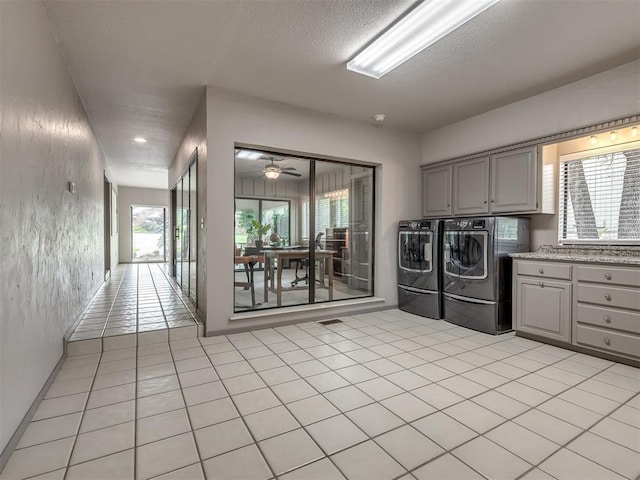 1011 Saint Andrews Dr, Edmond, OK 73025 - washroom with independent washer and dryer, cabinet space, plenty of natural light, a textured ceiling, and light tile patterned floors
