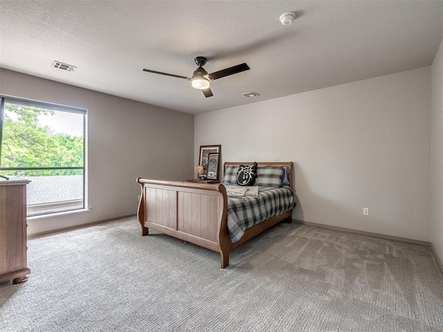 1011 Saint Andrews Dr, Edmond, OK 73025 - bedroom with light carpet, a ceiling fan, and a textured ceiling