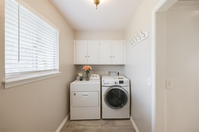 3205 NW 54th Cir, Oklahoma City, OK 73112 - washroom with cabinet space, independent washer and dryer, and light wood-type flooring