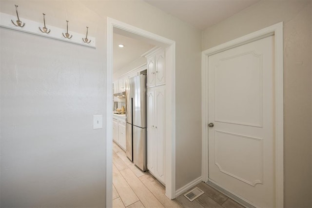 3205 NW 54th Cir, Oklahoma City, OK 73112 - hall featuring light wood-style floors and baseboards