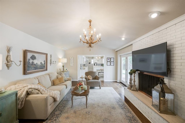 3205 NW 54th Cir, Oklahoma City, OK 73112 - living room featuring wood finished floors, a chandelier, vaulted ceiling, and brick wall
