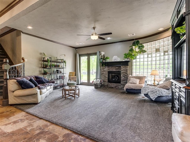 9408 S Caldwell Dr, Midwest City, OK 73130 - living room with ceiling fan, crown molding, a stone fireplace, recessed lighting, and stairs